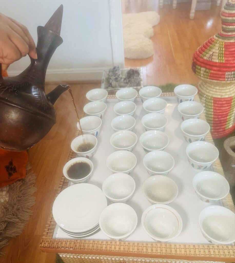 serving Ethiopian coffee in traditional cup called Cini